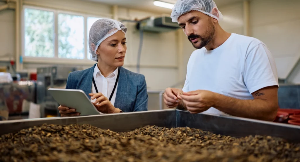 food processing plant manager and worker inspecting food